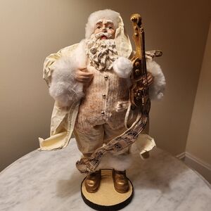 Santa Claus Figurine with A Golden Fiddle And Sheet Music